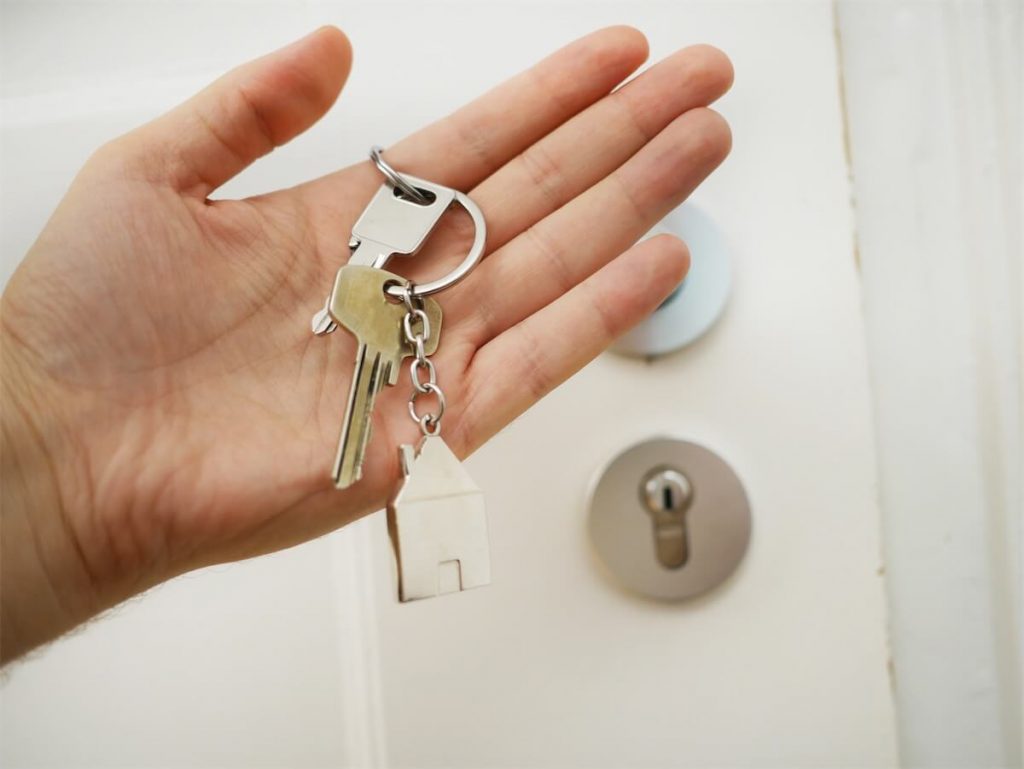 Man holding the key to his home, which is due for a home loan health check