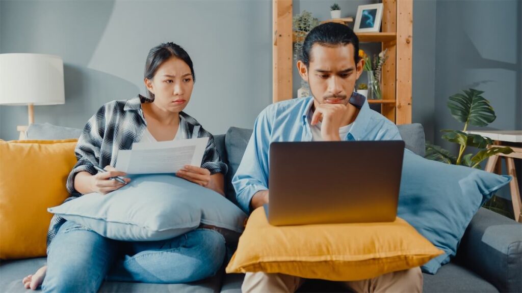 A young couple researching whether to get a BTO or buy an HDB resale flat in Singapore