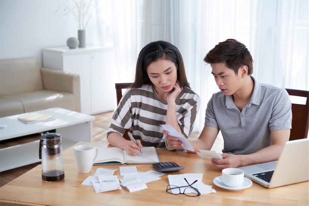 A Singaporean couple calculating the cost of refinancing their home loan in the current low-interest-rate environment 