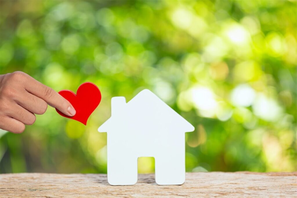 Images of cardboard house with a heart symbolising advantages of getting a property trust for your child