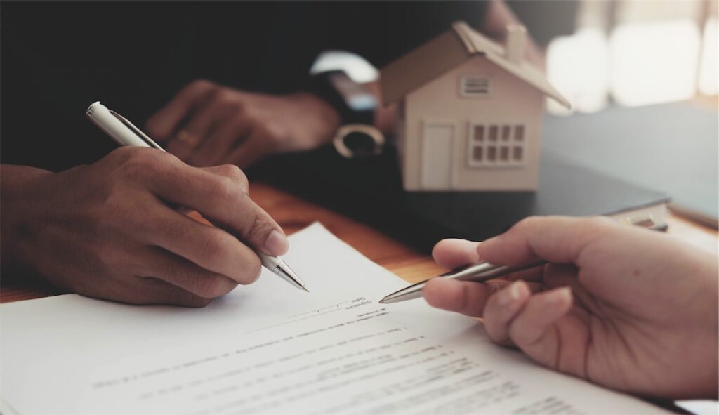 Image of someone signing their home loan IPA in a bank