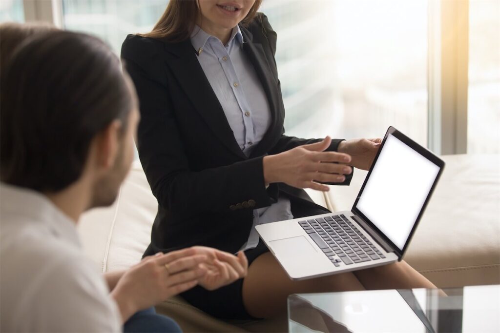 Image of a mortgage broker in Singapore explaining property stamp duty to a young couple