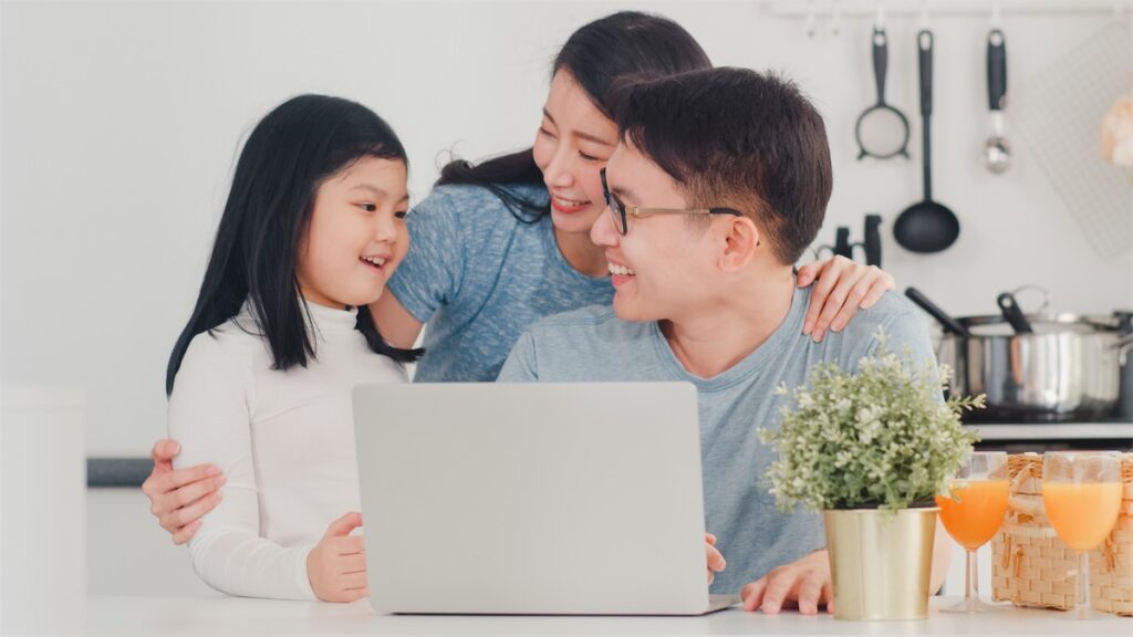 A Singaporean family looking happy in their private property condo in Singapore, which they paid the downpayment for using their CPF