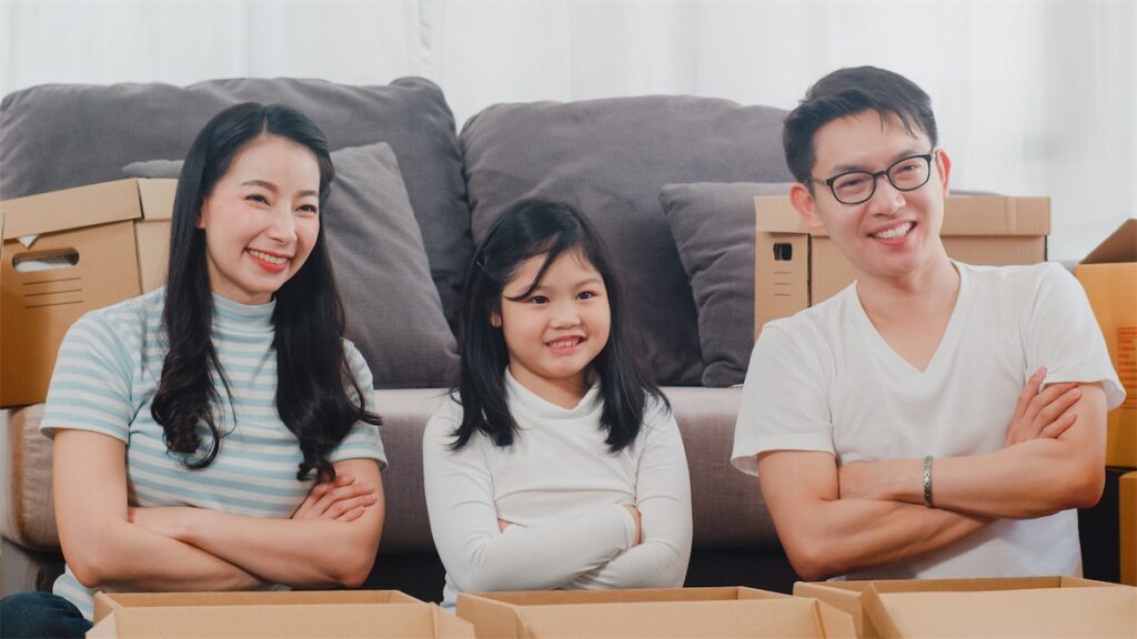 Family moving into their new home after getting the cheapest home loan package in Singapore with a mortgage broker 