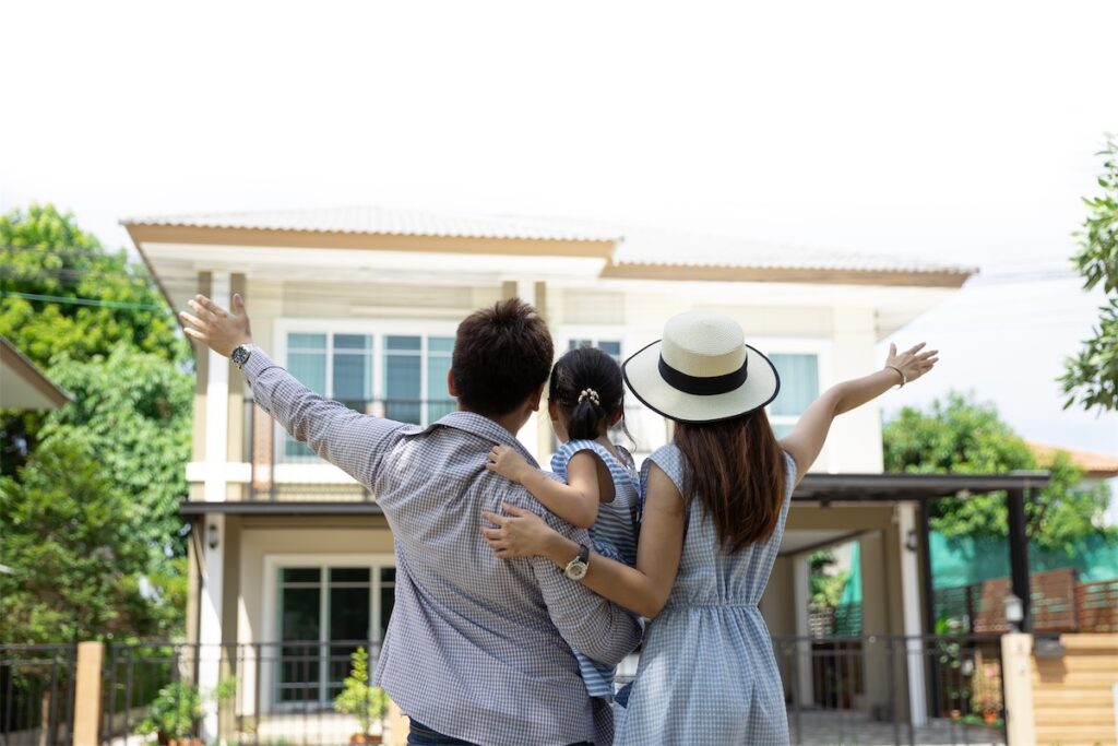 A happy family looking at their new home that was bought in a fire sale