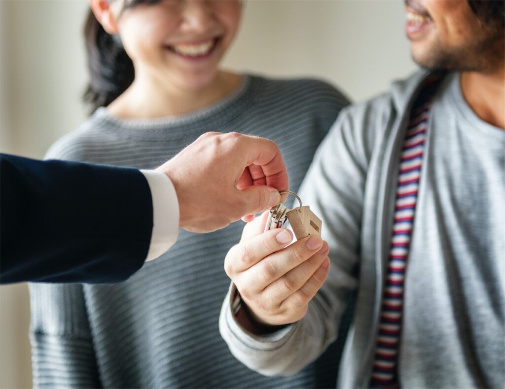 Property agent handing the owners the keys to their CCR condo in Singapore