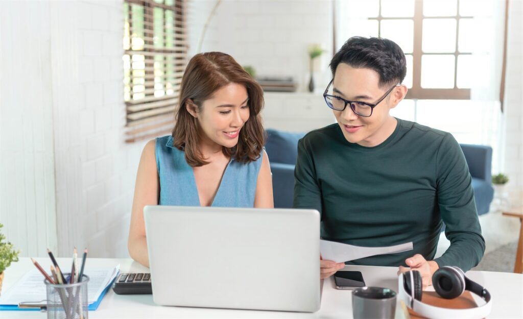 Husband and wife discussing home loan plans after calculating their TDSR limit.