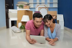 Image of a married couple moving into their first home in Singapore after seeking advice from a home financing advisor on their home loan process