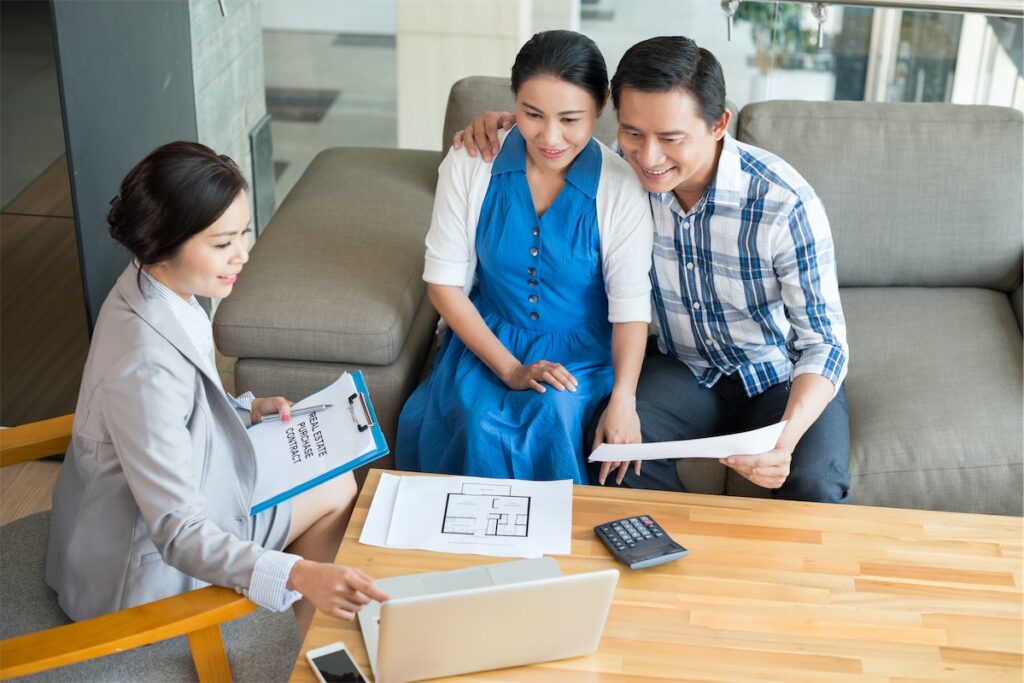 Couples looking at their credit score with a home loan advisor for home financing advice