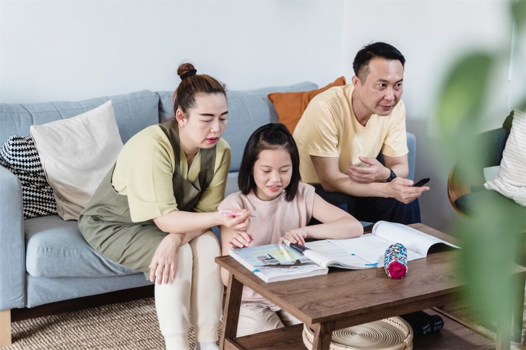 Singapore family enjoying their weekend at home while their home loan refinancing application is being processed with the help of a home financing advisors/mortgage broker